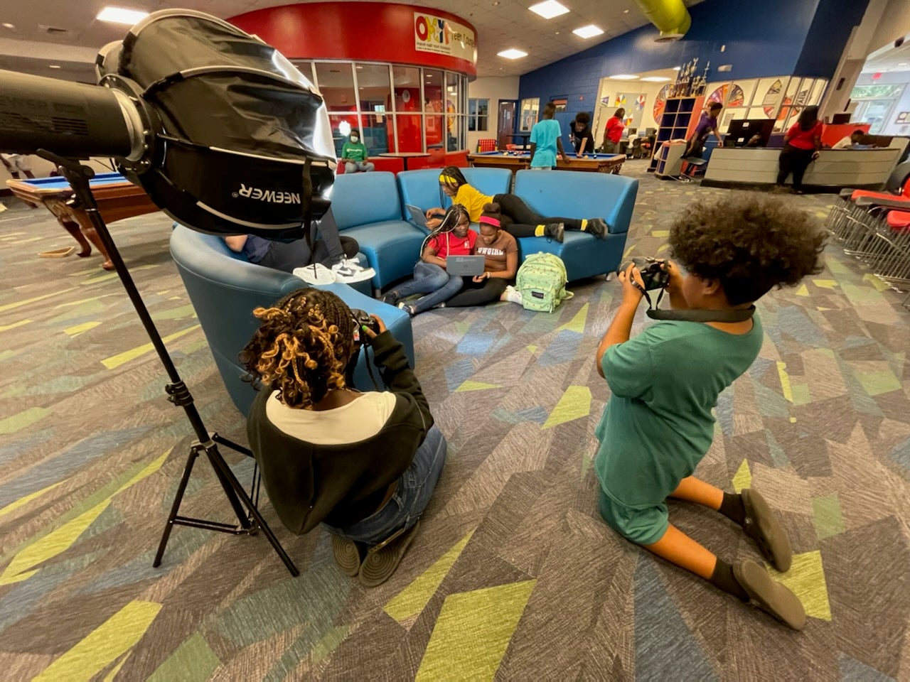 Students experiment with camera equipment after school.