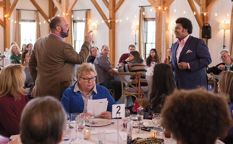 Opera singers perform amidst a dinner show.