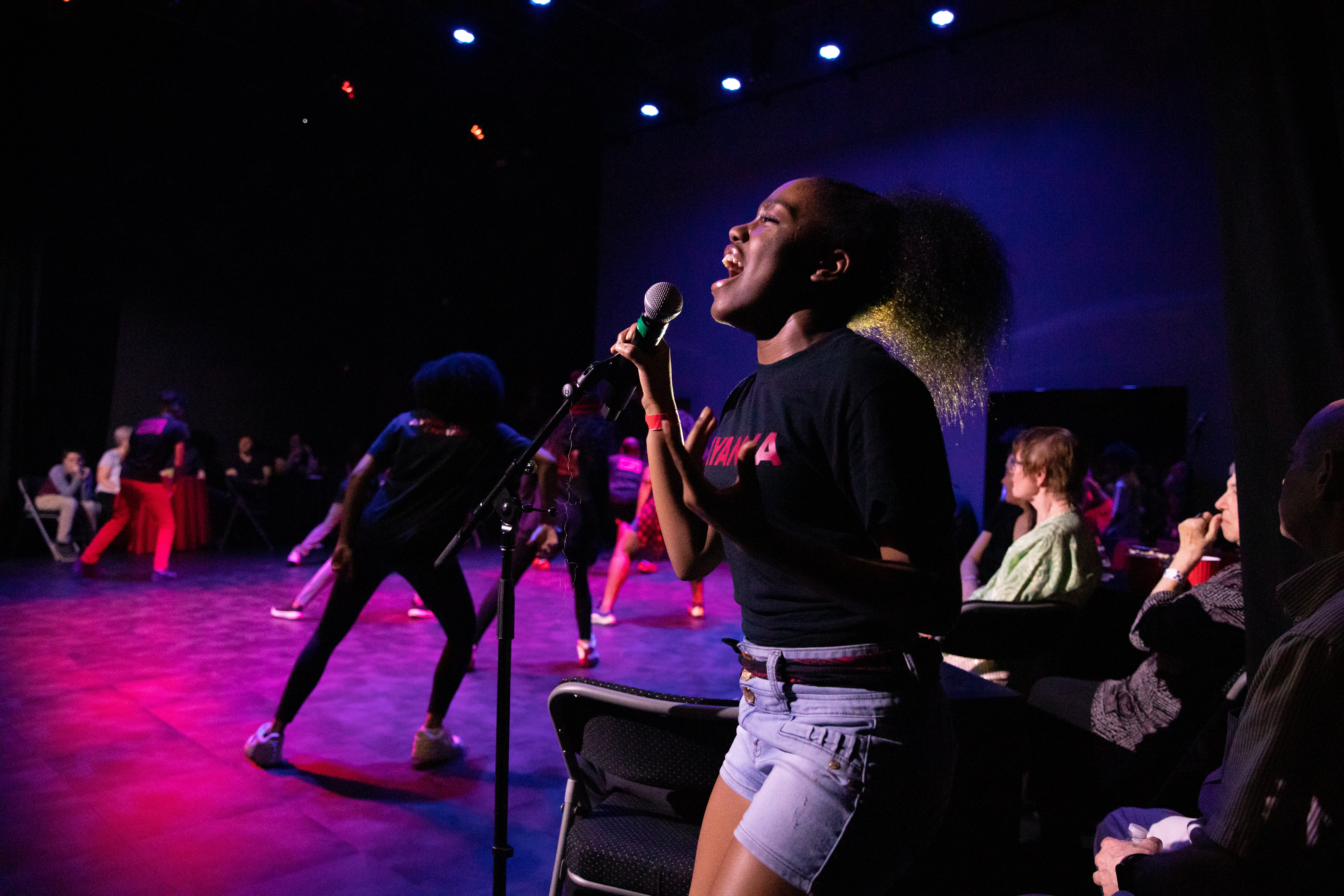 Multi-ethnic kids performing on stage